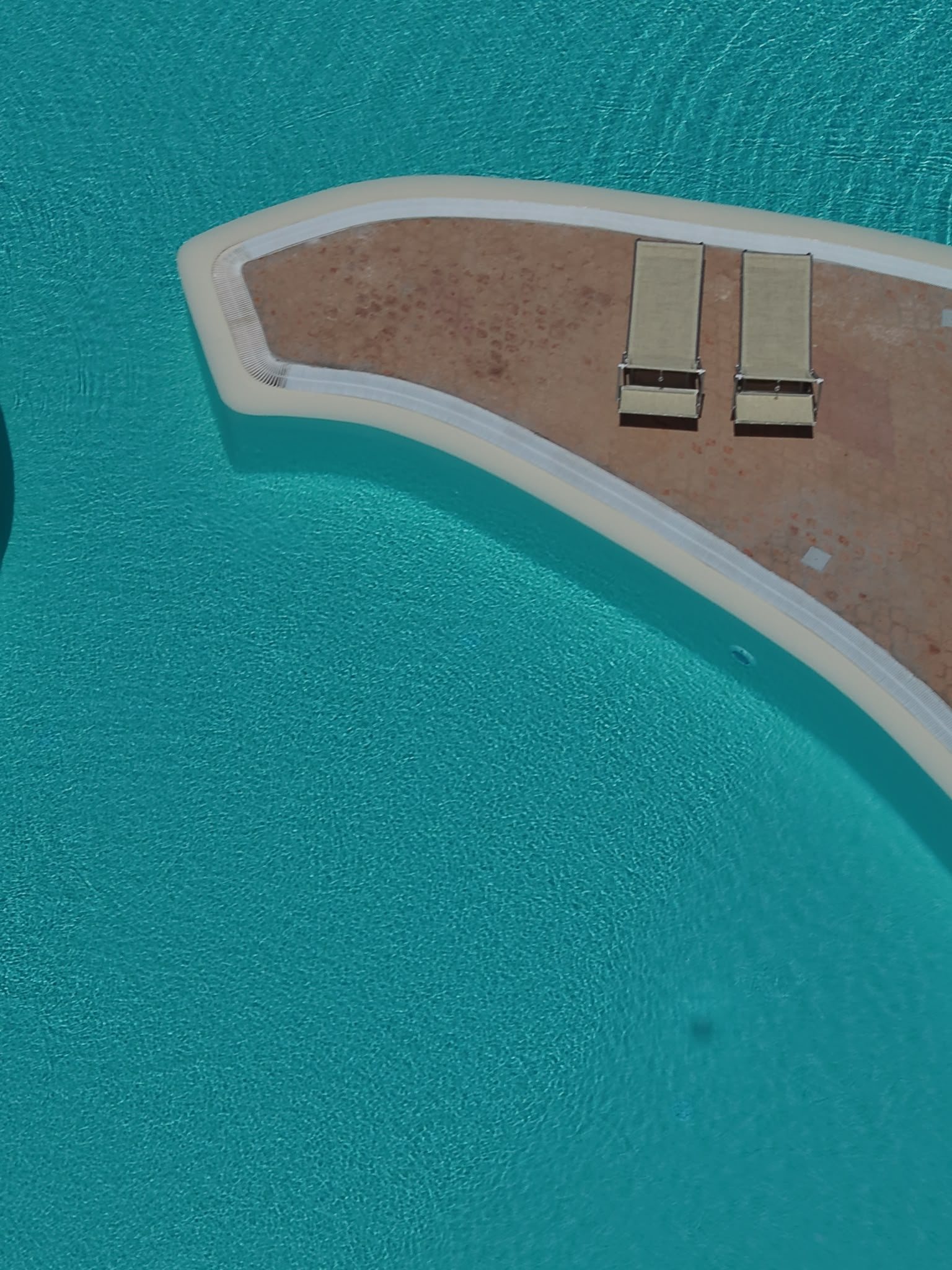 Sunbeds along the edge of the pool